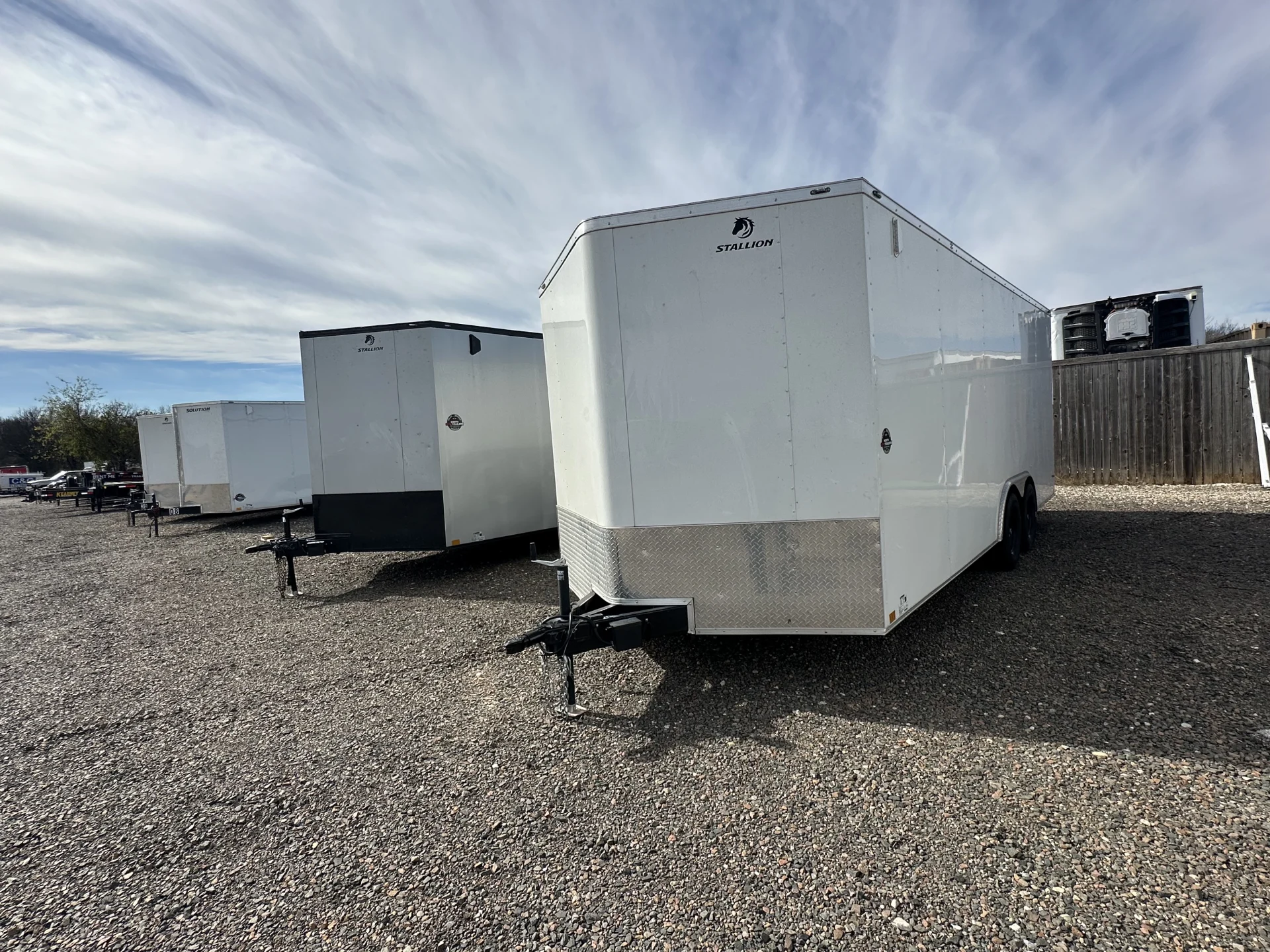 Rental trailers lined up and ready for customers at North DFW Trailers in Denton, Texas, including utility trailers, enclosed trailers, car haulers, and equipment trailers.
